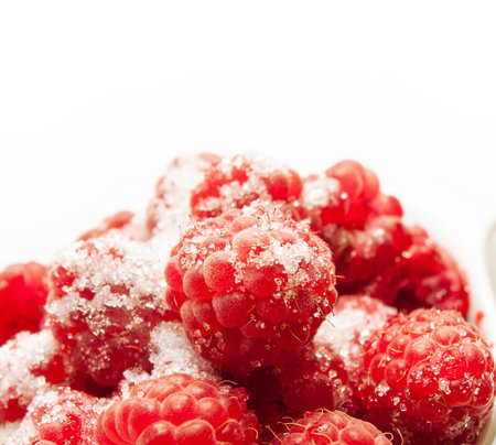 Ripe raspberries around white background. close up. 