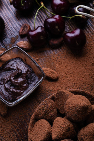 art background with healthy delicious dark truffles, chocolate and ingridients: natural cocoa beans,...