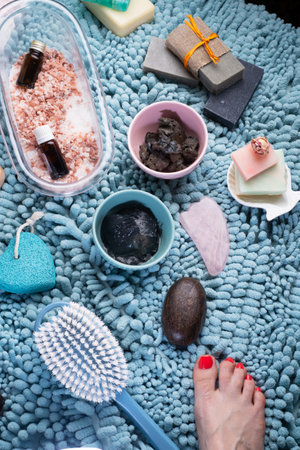 natural healing spa set with salt, healing mud and soap on blue bath mat. flay layの写真素材
