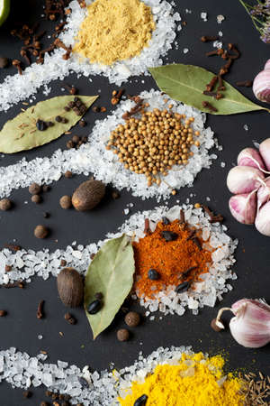 Spices and seeds served in salt spoon at black background. seasonings, Colorful natural meal additives. healthy food concept. close upの写真素材