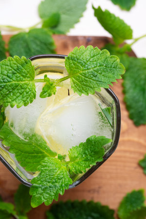 fresh lemonade served in glass with melissa and ice. top view. close up