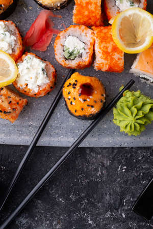 sushi roll set served at gray tray at black table. flat lay. close upの写真素材
