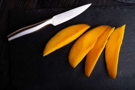 Ripe egyption Mango slices served at black dish. close upの写真素材