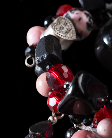 different bracelets with black and red semipreciouse stones with natural lava, shungite, hematite, rhodonite . macro shotの写真素材
