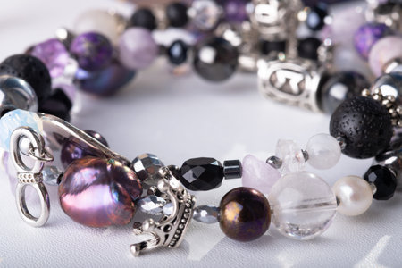 stylish jewelry bracelet with semiprecious and crystals on white background. hobby and fashion concept. extreme macro shotの写真素材