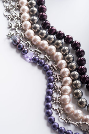 different colors pearl beads pesented together against white background. fashion and jewelry conceptの写真素材