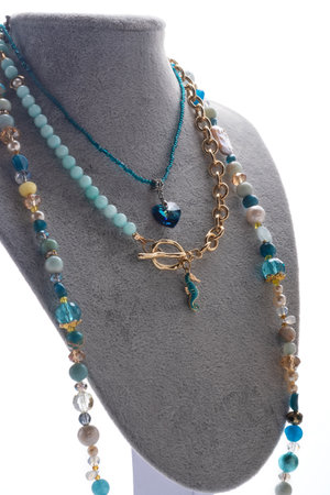 author set with different blue colors necklaces presented on maneken against white background. jewelry and hobby concept. trends2023の写真素材