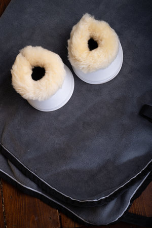 luxery hoof protectors with natural fur for sportive horses in complete with cover and halter. horse stuff and careの写真素材