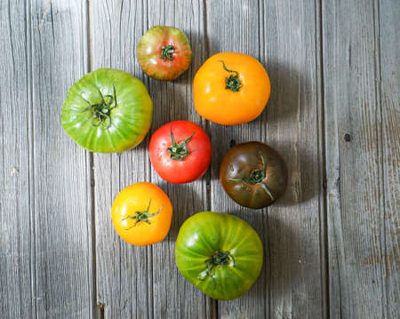 colorful heirloom tomatoes on wooden background.の写真素材