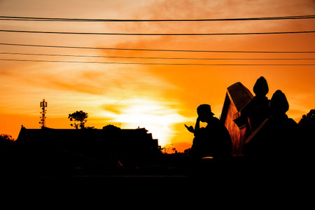 silhouette of man playing a phone on sunset in plengkung gading