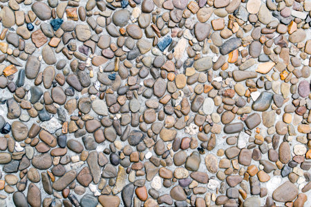 Beautiful stone wall background texture. pebble texture in concrete, small pebbles on the wall, on...