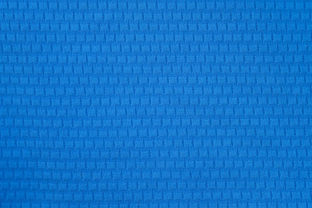 Blue polyester fabric background. A fragment of a t-shirt for sports. Close-up polyester, synthetic...