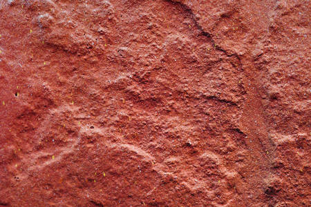 texture of a painted wall. cement plate red color background. wall with bumps and small pits.の写真素材