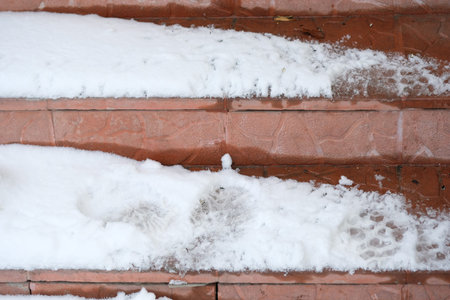 Snow on the steps of the house. Dangerous steps during snowfall.