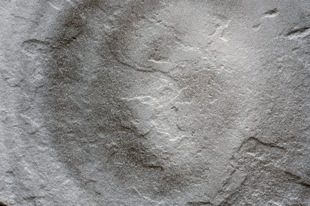 texture of a painted wall. cement plate gray color background. wall with bumps and small pits.