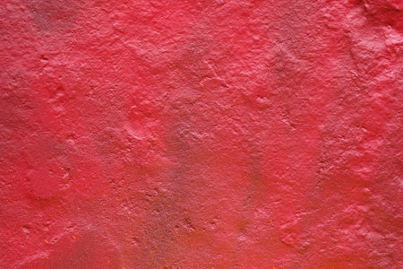 texture of a painted wall. cement plate red color background. wall with bumps and small pits.
