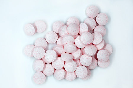Pink pills on a gray background top view. Vitamins B12 are useful food supplements.の写真素材