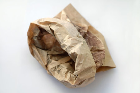 Baking paper bag on gray background top view. Empty used bun bag. Paper bags for food storage.