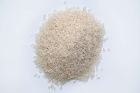 Raw white round grain rice top view. Groats for making rice porridge. Steamed rice on a white background.の写真素材