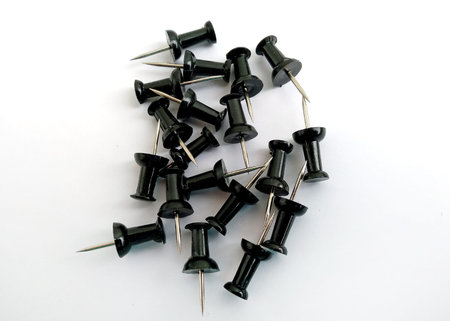 Black Stationery buttons on a white background. Office supplies top view.