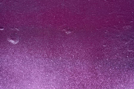 texture of a painted wall. cement plate light purple color background. wall with bumps and small pits.の写真素材