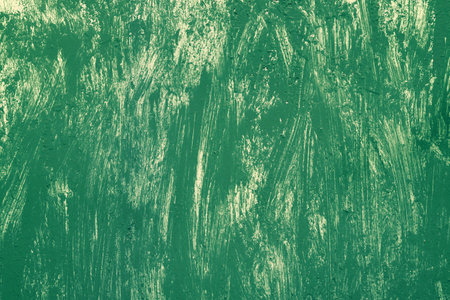 Green background with yellow dry brush strokes. Metal painted surface. Texture of green and yellow...