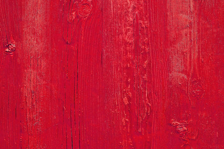Red wooden surface background. The texture of the tree painted red. Bright red wooden background....
