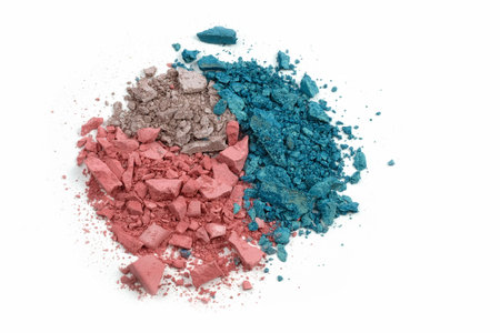 Broken eyeshadows in different colors on a white background. Cosmetics for eyes, make-up.
