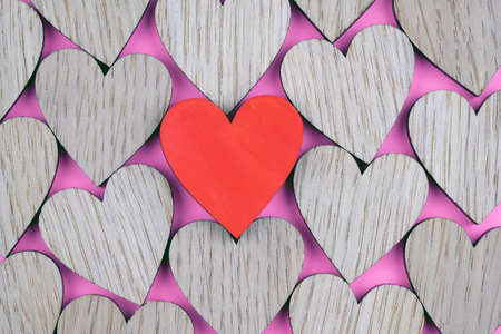 Red wooden heart on the background of other hearts top view. A background of different hearts. St. Valenite's Day theme.の写真素材