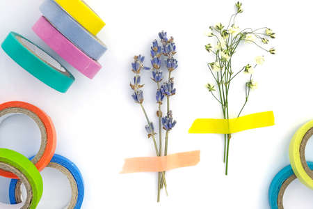 Set of paper sticky tape on a white background. Colored self-adhesive tape for decoration. Decorative adhesive tape for hobby. Small bouquet of dry lavender and gypsophila glued to paper, herbariumの写真素材