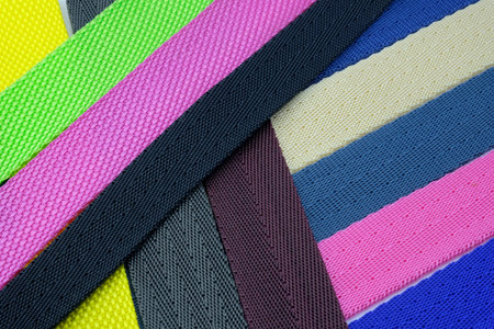 Colored background from belts folded diagonally. Colored polyester belts, sample palette for making...
