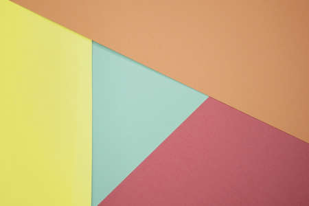 Abstract background from colored paper of red, yellow and green colors. Minimal geometric shapes and lines in pastel colors. Colored pastel paper texture minimalism. Cardboard backgrounds.の写真素材