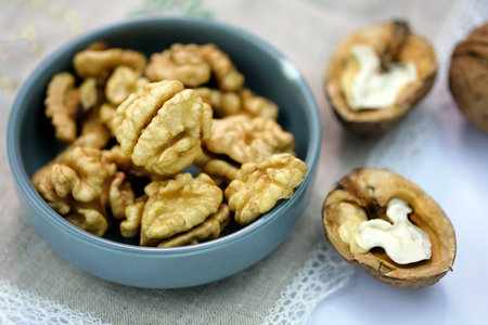Young grains of walnut top view. Walnuts peeled and in shell on a tablecloth on the table. Large...