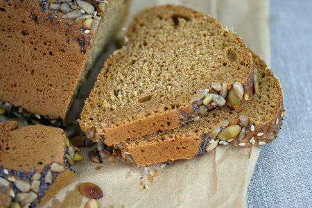 Cereal bread on a tablecloth close-up. Yeast-free bread made with rye flour. Triangular bread with...