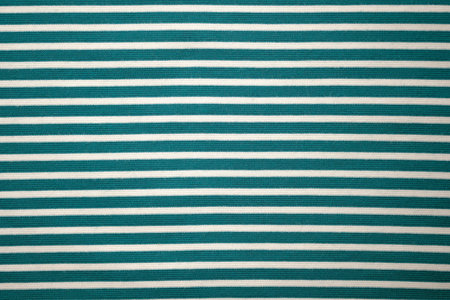 Fabric green cotton striped top view. Cotton and polyester fabric texture. Close-up textiles.