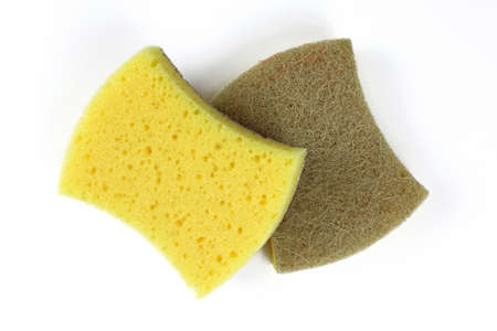 Dish washing sponge on a white background. Two sponges made of parolon and sisal close-up. A sponge with a yellow soft and brown hard side.の写真素材