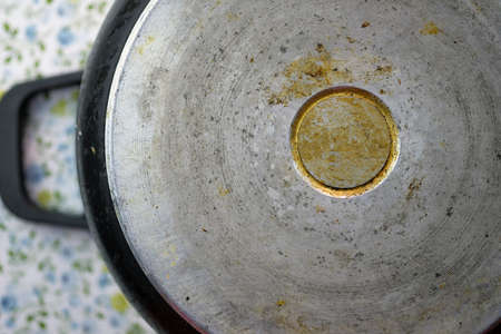 The reverse side of the pan is a top view. An old metal pan with drops of fat. The bottom of the cooking pot.の写真素材