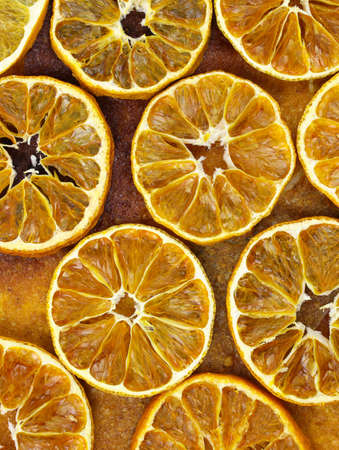 Dried sliced oranges top view background. Dried citrus fruits at home. fruit chips close up.の写真素材