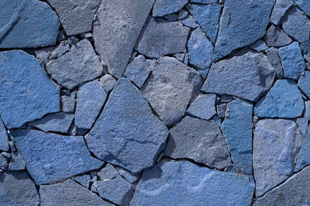 Blue stone wall background. rock wall texture photo. surface natural. Detail of a stone wall with different sizes of rocks. tonsの写真素材