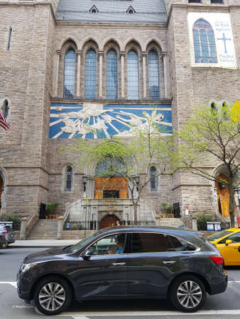 The facade of the Catholic Church of St. Peter in New York is an old building with sculptures depicting saints against the sky.のeditorial素材