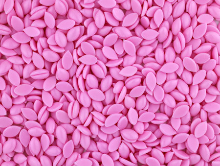 Beautiful granules of pink wax for depilation face area top view. Epilation, depilation, unwanted...