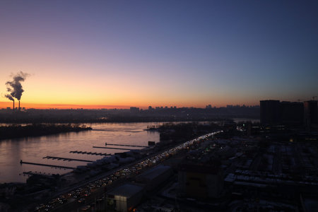 Panorama of the evening city with high-rise buildings and a river. View of the city of Kyiv in Ukraine in the evening from the window.の写真素材