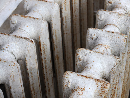 White old cast iron batteries close up. Old cast iron central heating battery. Scrap metal and recyclables. Delivery of scrap metal, replacement of the heating system in the apartment.の写真素材