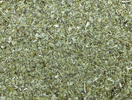 Dry mate tea close up. Pile of mate tea leaves top view. dried and crushed leaves of Paraguayan holly or the so-called thorny or bushy holly.の写真素材