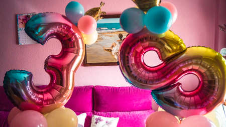 Colorful number-shaped balloons at a birthday partyの写真素材