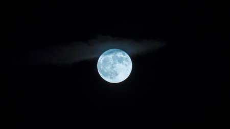 Moon shining through the cloudsの写真素材