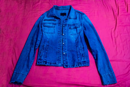 Denim jacket on pink backgroundの写真素材