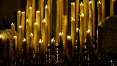 Set of lit candles at nightの写真素材