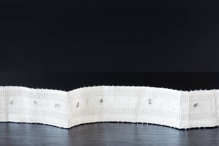 Paper seeds tape on black wooden table.の写真素材