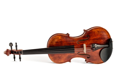 Reclined standard violin made of wood isolated on whiteの写真素材